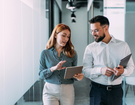 Two salespeople walking down a hallway