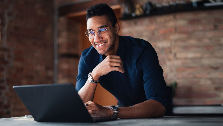Smiling man at laptop