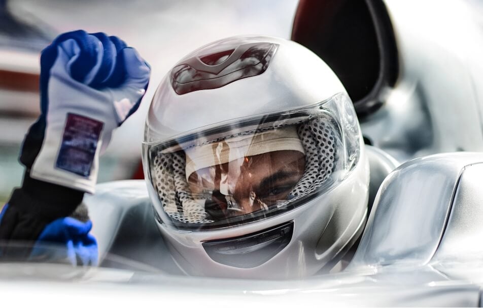 Race car driver in a light-colored helmet